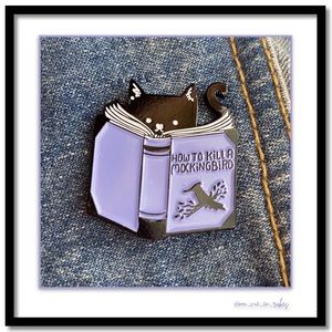 Cat reads “How to Kill a Mockingbird”